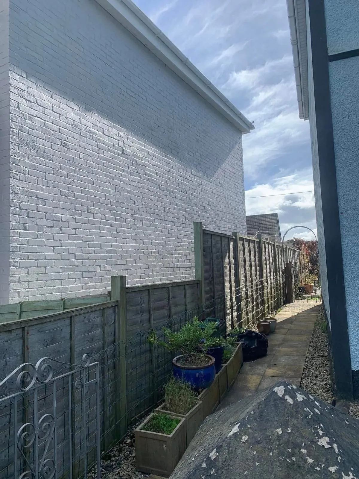 Freshly painted brick wall after preparation and masonry paint in Exmouth